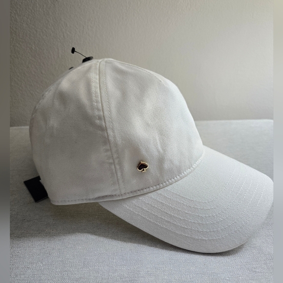kate spade white baseball cap with gold and pink spade charm